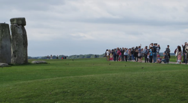 Stonehenge crowds looking on behind rope