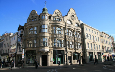 Shoppers pass high end shops on London's Bond Street. Known for