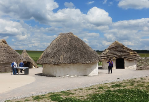 Stonehenge Neolithic houses on day tour from London