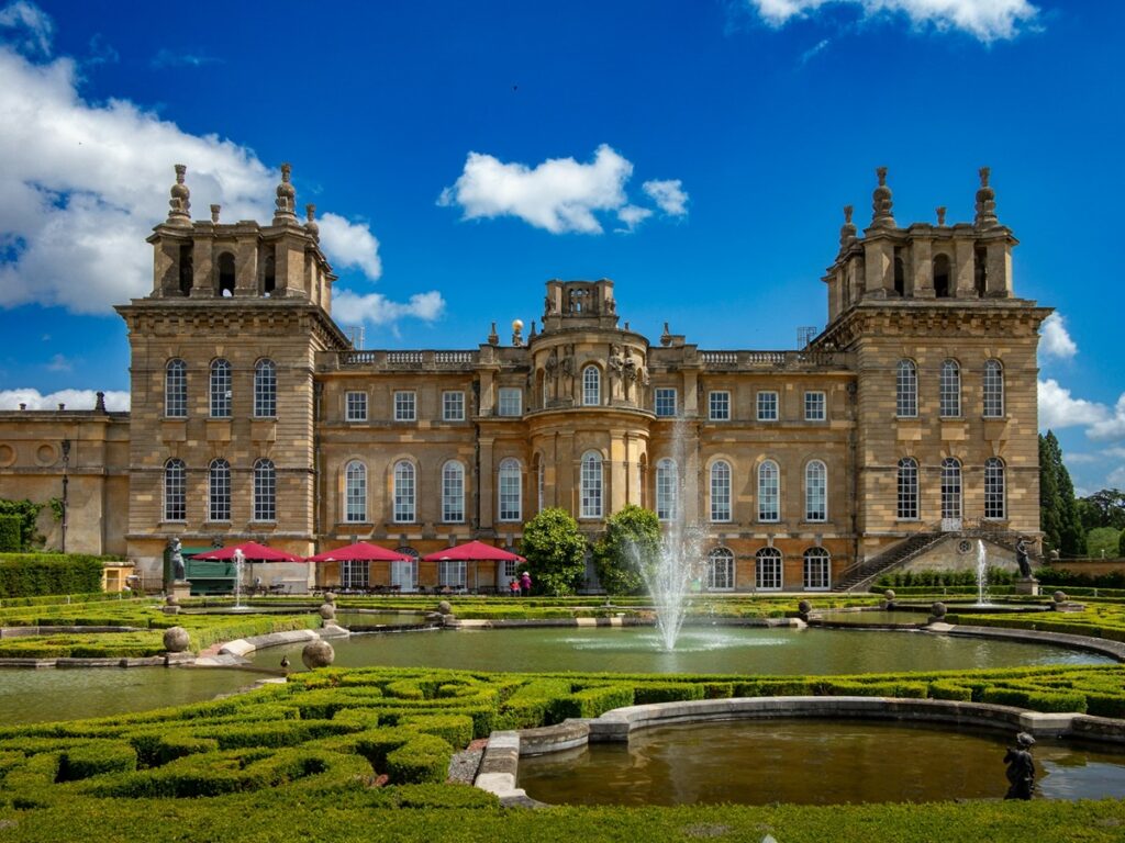 Facade of Blenheim Palace with gardens and fountain