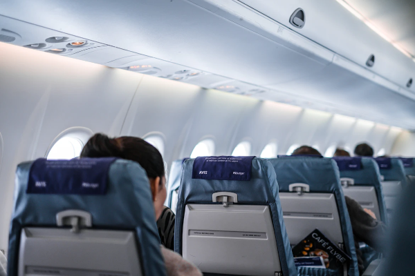 Image of a person sitted in an airplane seat