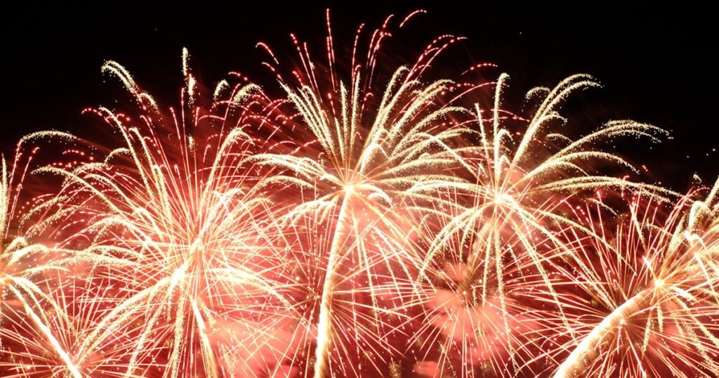 Looking up at fireworks in the night sky