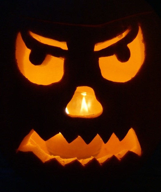 Glowing carved pumpkin lantern