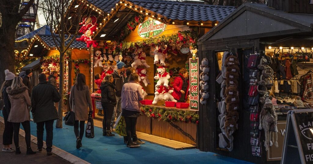People standing at a Christmas chalet stall